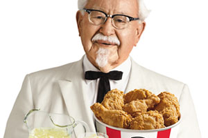 K.F.C. point of purchase display: Colonel Sanders holds a tray of food.